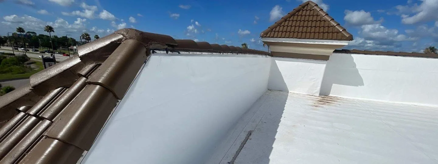 After: new white TPO roof recovery system at the Quality Inn